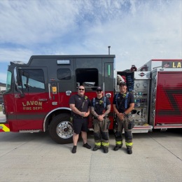 firefighters standing in front of fire engine