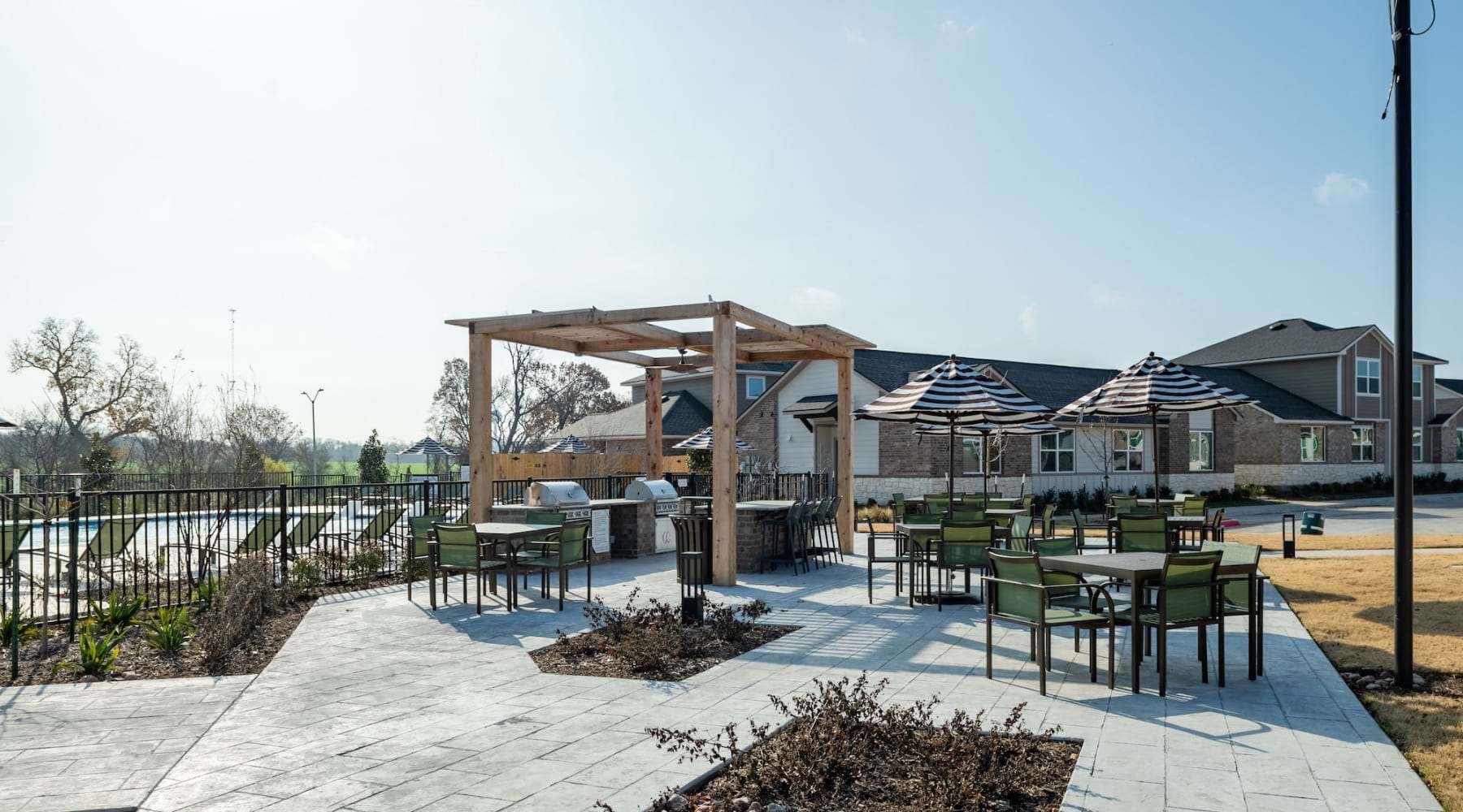 a patio with tables and chairs and a covered patio
