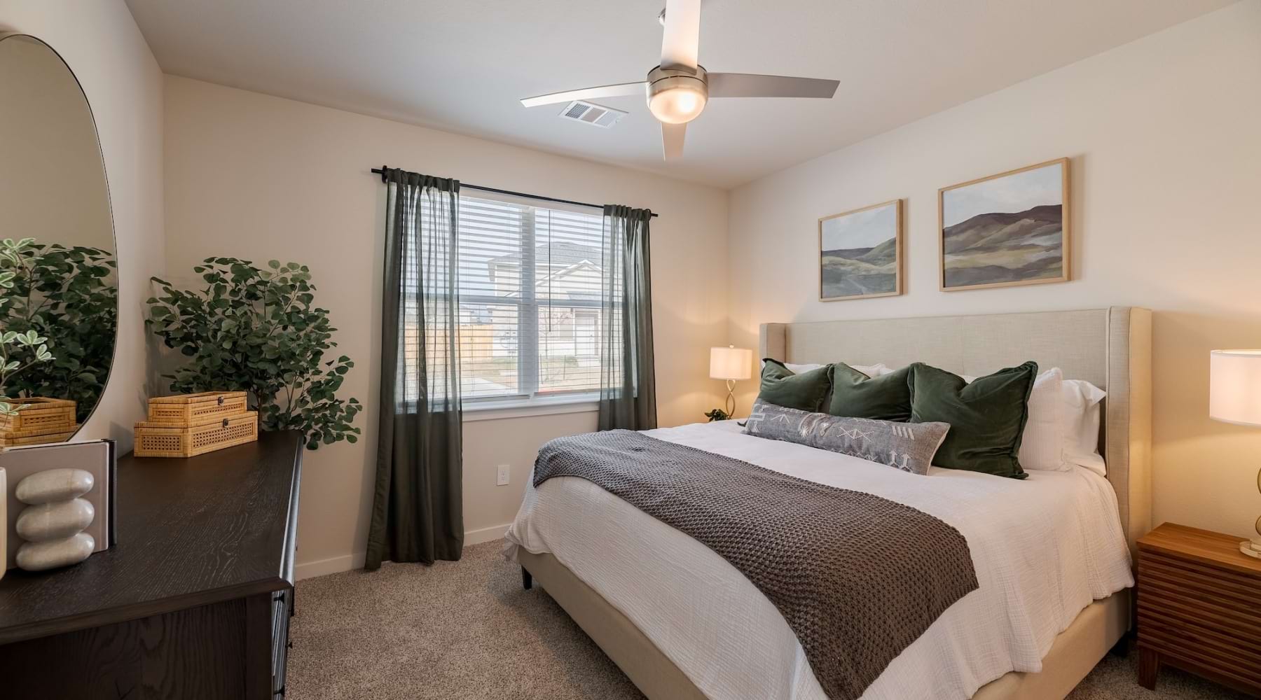 a bedroom with a bed and a fan