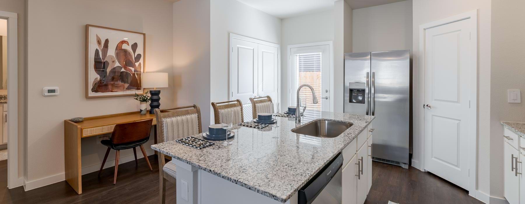 a kitchen with a marble island